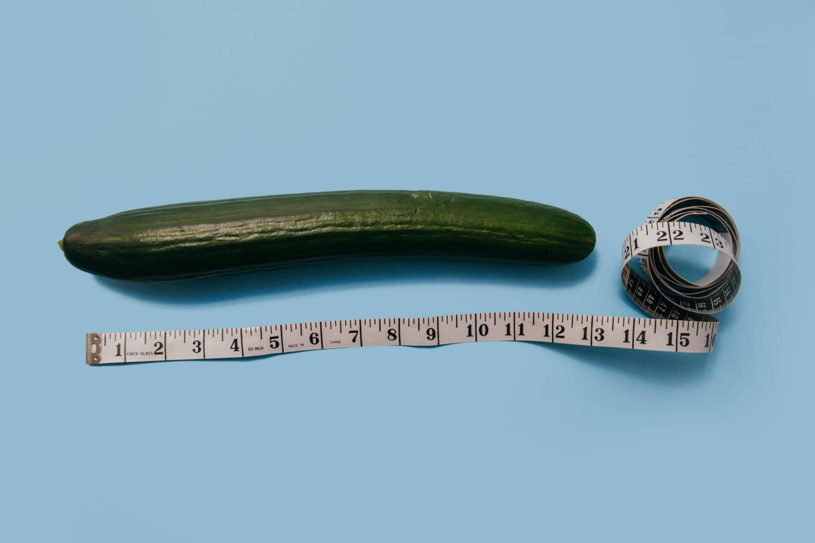 Photo of a cucumber with a tape measure beside it.