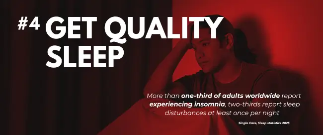 Fatigued man struggling with sleep, red lighting, supporting article on boosting sex drive naturally