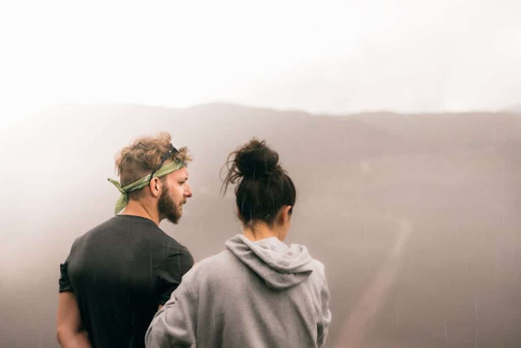 couple standing on the field photography